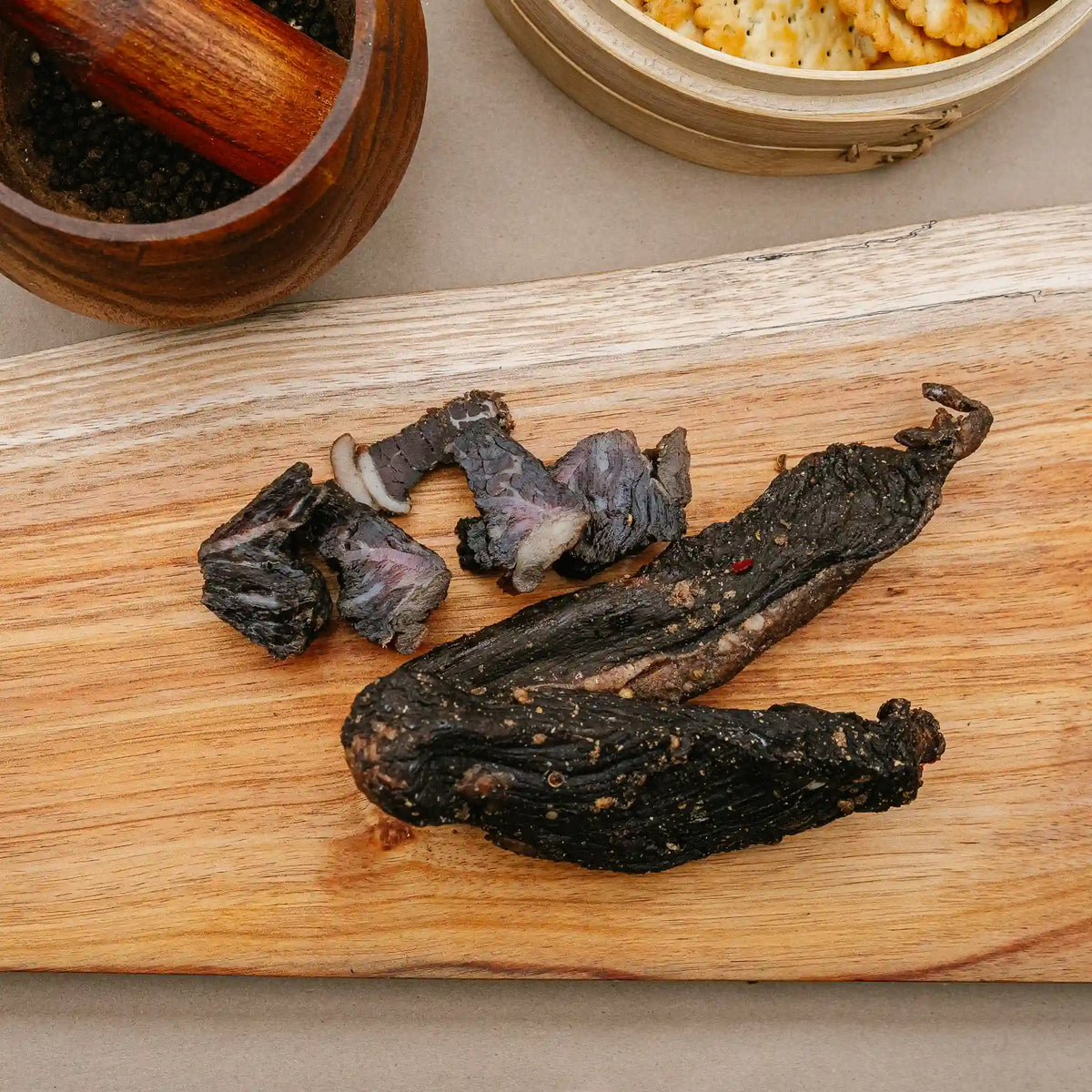 Sliced biltong from Greeff's Butchery, Knysna, on a wooden board.